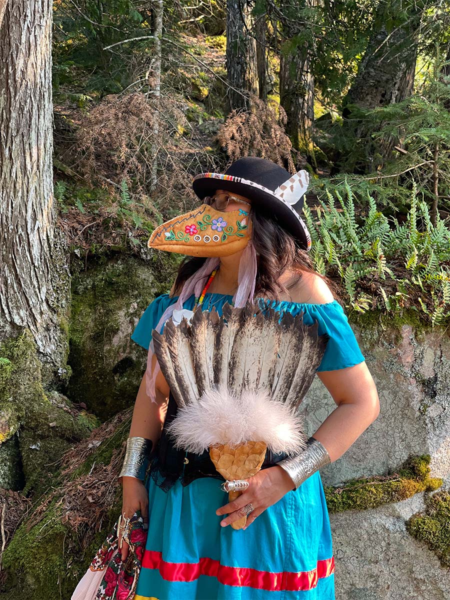Delores wearing her beaded plague doctor face mask